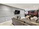 Beautifully finished basement showcasing a comfortable seating area and a stylish bar for entertaining guests at 16316 Brookhollow Dr, Westfield, IN 46074