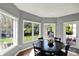 Charming dining room area featuring natural light from multiple windows, wood floors and a dining table at 16316 Brookhollow Dr, Westfield, IN 46074