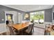 Dining area with rustic wooden table and chairs next to a large window with a view to the outside at 16316 Brookhollow Dr, Westfield, IN 46074