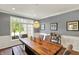 Dining room with hardwood floors, large window, table, and chairs set with tasteful decor at 16316 Brookhollow Dr, Westfield, IN 46074