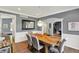 Dining area with hardwood floors, modern lighting, and archway to front room; set for a relaxed gathering at 16316 Brookhollow Dr, Westfield, IN 46074