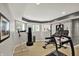 Home gym featuring treadmill, weightlifting equipment, and ample natural light for energizing workouts at 16316 Brookhollow Dr, Westfield, IN 46074