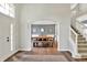 Inviting foyer with staircase and dining room, featuring hardwood floors and natural light at 16316 Brookhollow Dr, Westfield, IN 46074