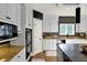 Spacious kitchen with stainless steel appliances, granite countertops, and a mosaic tile backsplash at 16316 Brookhollow Dr, Westfield, IN 46074