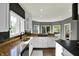 Well-lit kitchen featuring granite counters, stainless sink, dark backsplash, and lots of natural light at 16316 Brookhollow Dr, Westfield, IN 46074