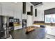 Bright kitchen showcases a center island, stainless steel fridge, white cabinetry and dark counter tops at 16316 Brookhollow Dr, Westfield, IN 46074