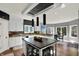 Modern kitchen with white cabinets, dark island, and sleek black pendant lighting at 16316 Brookhollow Dr, Westfield, IN 46074