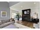 Open-concept living room boasting a cozy gray sofa, plush ottoman, and modern fireplace at 16316 Brookhollow Dr, Westfield, IN 46074