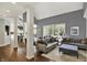 Comfortable living space with large windows, hardwood floors, and an open connection to the kitchen at 16316 Brookhollow Dr, Westfield, IN 46074