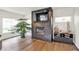Hardwood floors accentuate a contemporary fireplace with a mounted TV and stylish storage cabinet at 16316 Brookhollow Dr, Westfield, IN 46074