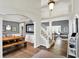 Open-concept living spaces with a modern dining area, staircase, and view of the living room showcasing hardwood flooring at 16316 Brookhollow Dr, Westfield, IN 46074
