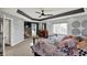 Main bedroom with tray ceiling, carpet, and a view to the ensuite bathroom at 16316 Brookhollow Dr, Westfield, IN 46074