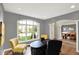 Home office featuring a black desk with large window and archway leading to dining room at 16316 Brookhollow Dr, Westfield, IN 46074