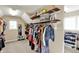 Organized walk-in closet featuring shelves, hanging racks, and a mirror at 16316 Brookhollow Dr, Westfield, IN 46074
