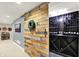 Rustic wood door sliding open to reveal a modern and organized wine cellar with custom shelving at 16316 Brookhollow Dr, Westfield, IN 46074