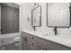 Modern bathroom with double vanity, sleek mirrors, and tiled shower-tub combination at 17339 Newton Main St, Westfield, IN 46074