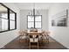 This bright dining room features a round table, wood floors, and large windows at 17339 Newton Main St, Westfield, IN 46074
