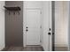 Entryway featuring a hall tree and coat hooks, adjacent to a white interior door at 17339 Newton Main St, Westfield, IN 46074