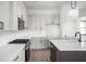 Bright kitchen with white backsplash, grey cabinets, and stainless steel appliances at 17339 Newton Main St, Westfield, IN 46074