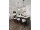Bright kitchen features an island with three stools and modern lighting fixtures at 17339 Newton Main St, Westfield, IN 46074