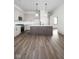 Modern kitchen with grey cabinets, a kitchen island, and stainless steel appliances at 17339 Newton Main St, Westfield, IN 46074