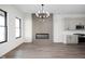 Living room opens up to the kitchen and features an electric fireplace and modern light fixture at 17339 Newton Main St, Westfield, IN 46074