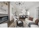 Bright open concept living space with wood floors, fireplace, and view of the kitchen at 17339 Newton Main St, Westfield, IN 46074