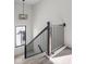 Staircase with dark wood banister and modern light fixture at 17339 Newton Main St, Westfield, IN 46074