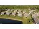 Overhead view of neighborhood featuring homes with yards and landscaping next to a pond at 18763 Abigail Cir, Westfield, IN 46062