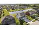 Aerial view of a neighborhood featuring a beautiful pond and multiple homes with well-manicured lawns and landscaping at 18763 Abigail Cir, Westfield, IN 46062