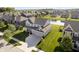 Aerial view of home with a three-car garage, well-manicured lawn and landscape in a quiet neighborhood near a pond at 18763 Abigail Cir, Westfield, IN 46062