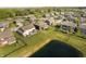 Homes in a community with manicured lawns and landscaping near a pond at 18763 Abigail Cir, Westfield, IN 46062