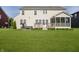 View of the backyard featuring a well-maintained lawn, deck, and hot tub, perfect for outdoor entertaining at 18763 Abigail Cir, Westfield, IN 46062