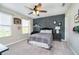 Inviting bedroom with a ceiling fan, complemented by sports-themed decor, and a comfortable bed at 18763 Abigail Cir, Westfield, IN 46062