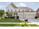 Charming two-story home featuring a well-manicured lawn, a three-car garage, and classic architectural details at 18763 Abigail Cir, Westfield, IN 46062