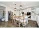 Contemporary kitchen features an island with seating, stainless steel appliances, and white cabinetry for a clean, modern look at 18763 Abigail Cir, Westfield, IN 46062