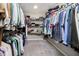 Spacious walk-in closet with ample shelving, clothing racks, and neutral carpet flooring at 18763 Abigail Cir, Westfield, IN 46062