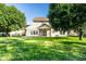 Large backyard with a screened porch, mature trees providing ample shade, and a well-maintained lawn at 197 Ceejay Dr, Greenwood, IN 46142