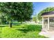 Lush backyard with a large tree and a screened-in porch at 197 Ceejay Dr, Greenwood, IN 46142