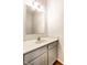 Bathroom featuring a light grey vanity with chrome faucet fixtures and a decorative mirror at 197 Ceejay Dr, Greenwood, IN 46142