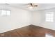 An empty bedroom with hardwood floors and light walls, featuring a ceiling fan and two windows at 197 Ceejay Dr, Greenwood, IN 46142