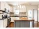 Well-lit kitchen featuring stainless appliances, a kitchen island, and marble backsplash at 197 Ceejay Dr, Greenwood, IN 46142