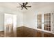 Bright room with dark hardwood floors, a modern ceiling fan, and elegant french doors at 197 Ceejay Dr, Greenwood, IN 46142