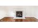 Hardwood floors leading up to the fireplace with a white mantle and tile work at 197 Ceejay Dr, Greenwood, IN 46142