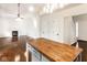 Open-concept living room with fireplace, hardwood floors, and kitchen island with butcher block countertop at 197 Ceejay Dr, Greenwood, IN 46142