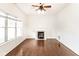 Bright living room featuring hardwood floors, a ceiling fan, and a cozy fireplace with white mantle at 197 Ceejay Dr, Greenwood, IN 46142
