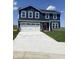 Charming two-story home with navy siding, white trim, a red door, and a spacious two-car garage at 2057 Eldin Ct, Whitestown, IN 46075