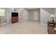 Spacious basement area with stairs, doors, laminate floors, and ample room for various activities at 2075 Rhettsbury St, Carmel, IN 46032