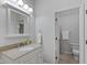 Neat bathroom featuring a granite vanity top, cabinet storage, and well-lit mirror at 2075 Rhettsbury St, Carmel, IN 46032