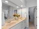 Bright bathroom featuring a double sink vanity with granite countertops and a large mirror at 2075 Rhettsbury St, Carmel, IN 46032